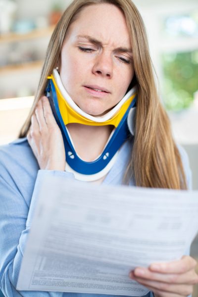 Woman,At,Home,Reading,Letter,After,Receiving,Neck,Injury