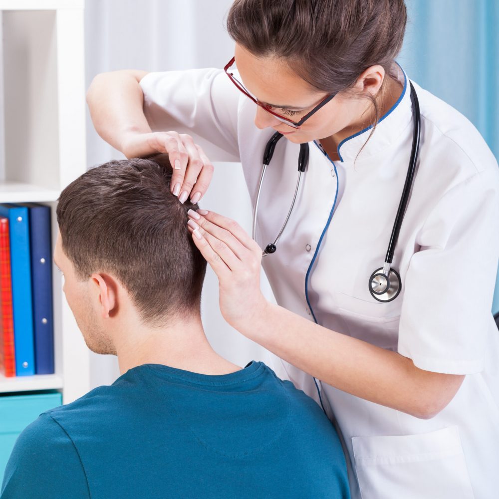 Doctor,Inspecting,Skin,Of,Head,Of,Man